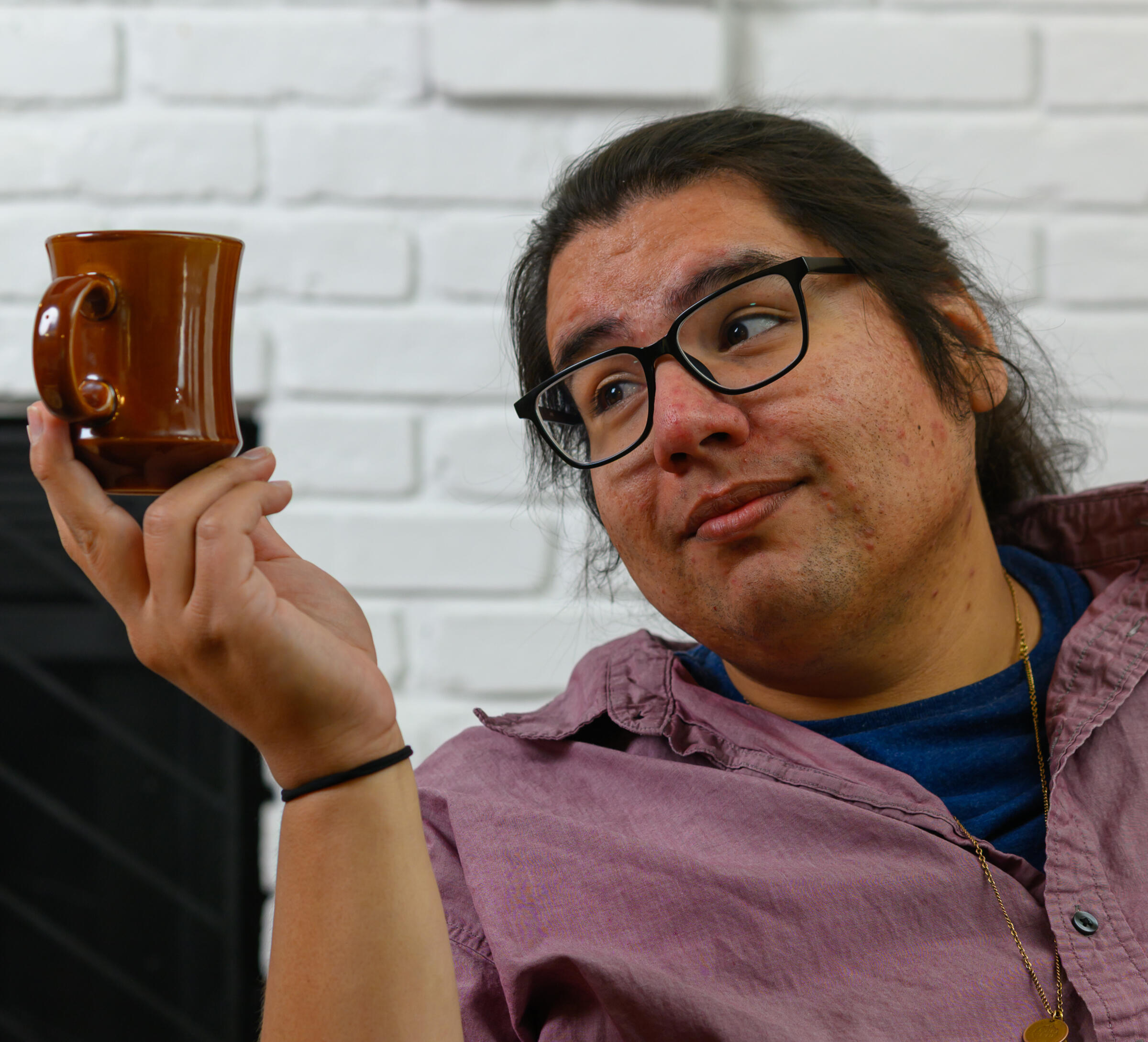 Tyler Corbine staring comically at a coffee cup